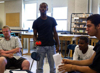 Led by instructor Tory Bullock (standing), summer school students participated in a spoken word poetry exercise at Boston Arts Academy. “It was very, very difficult to get kids to really participate in the beginning,’’ Bullock said, though some did open up. (Kayana Szymczak for The Boston Globe) 
