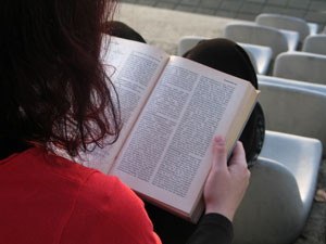 Girl Reading a Textbook in a lecture room