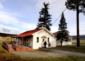student and teacher enter a school house
