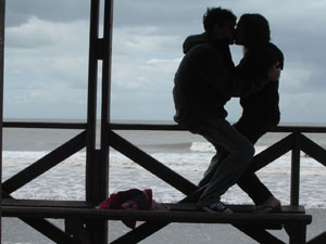 girl and guy sitting on the beach