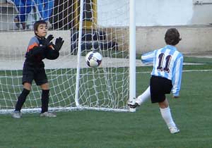 two boys playing soccer